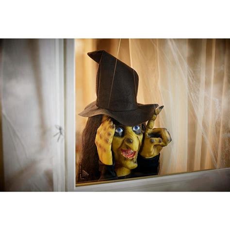 Halloween themed window decoration with tapping witch